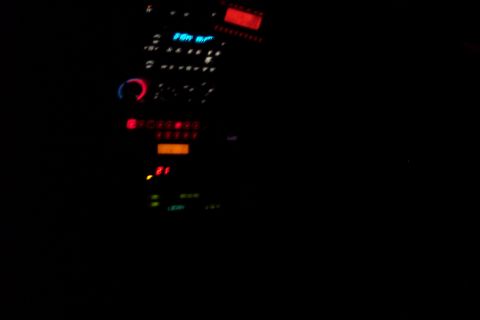 2001 Ford Crown Victoria - The illuminated dashboard of a vehicle shows radio and climate controls, with a digital display reading '21'.