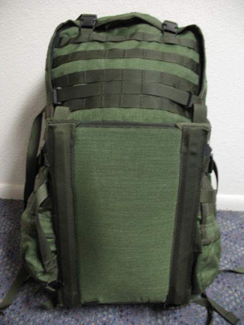 1991 Ford Bronco - A green tactical backpack with multiple straps and pockets is shown against a wall and carpeted floor.