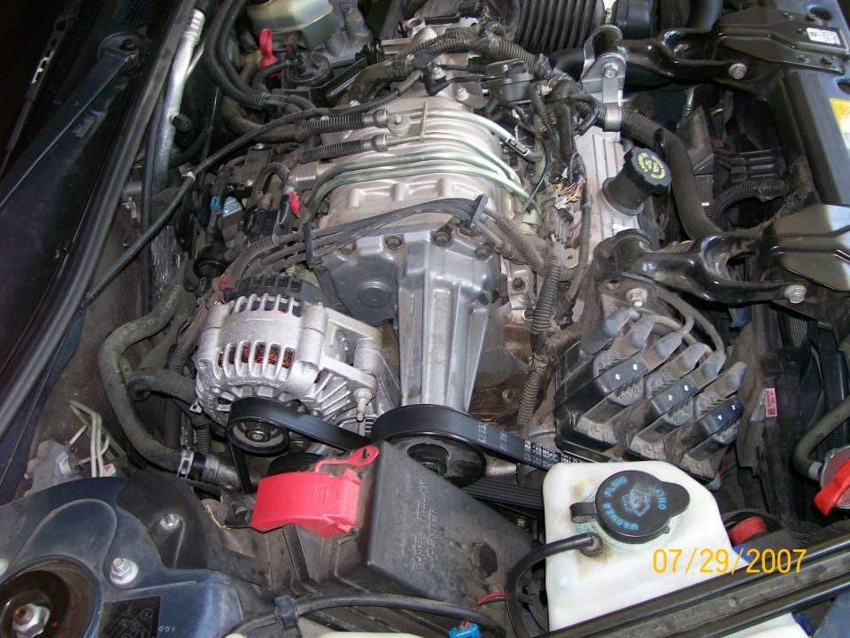 Supercharged GM 3800 V6 engine bay with alternator, serpentine belt and blower