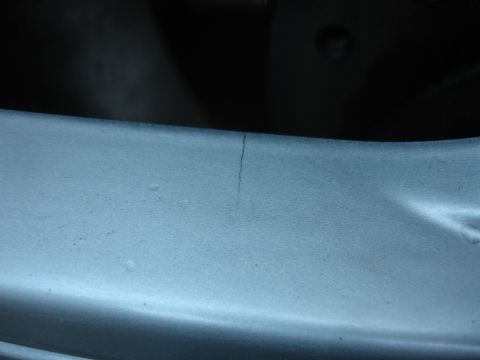 1993 Ford Taurus - A crack is visible on this painted metal part.