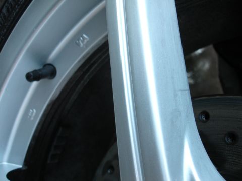1993 Ford Taurus - A close-up view of a vehicle's wheel and tire assembly, showing the brake rotor and valve stem.