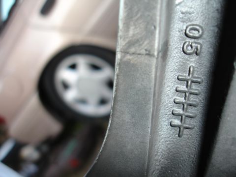 1993 Ford Taurus - A close-up view of a wheel rim shows stamped markings, but no clear year identification.