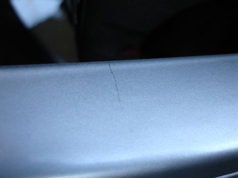 1993 Ford Taurus - A hairline crack is visible on the silver interior trim of a vehicle.
