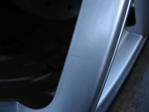 1993 Ford Taurus - This image shows a cracked alloy wheel rim, not a 1993 Ford Taurus.