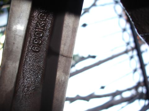 1993 Ford Taurus - A close-up view of a cracked wheel rim shows stamped lettering indicating a weight capacity.