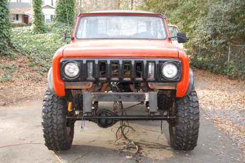1994 Ford Bronco - Front view of an orange International Harvester Scout with off-road tires and a modified front end.