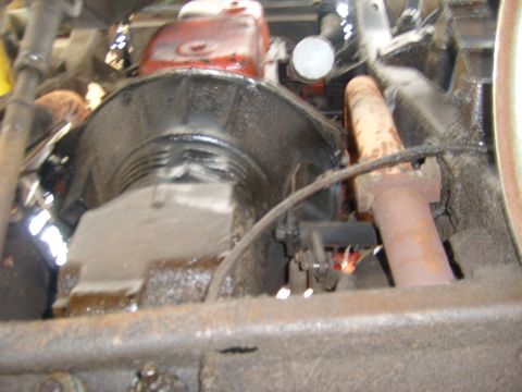 1994 Ford Bronco - Underside view of engine and transmission components, showing various mechanical parts and some rust.