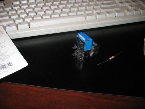 1995 Ford C-350 (Centurion Conversions) - A blue relay and a resistor are placed on a desk next to a computer keyboard.