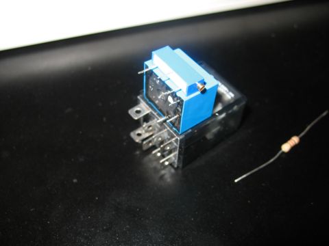 1995 Ford C-350 (Centurion Conversions) - An automotive relay and a resistor are shown on a dark surface.