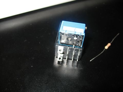 1995 Ford C-350 (Centurion Conversions) - A close-up view of an automotive relay and a resistor, likely for electronic repair or modification.
