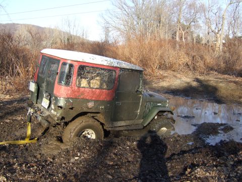 1976 Toyota Land Cruiser - This 1976 Toyota Land Cruiser is deeply stuck in thick mud, with a tow strap attached to the rear.