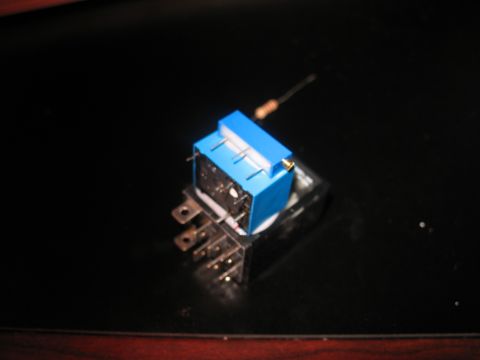 1995 Ford C-350 (Centurion Conversions) - A blue relay with a resistor attached is shown on a dark, reflective surface.