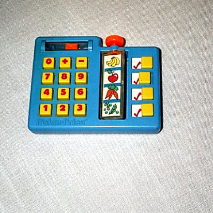 1991 Ford Bronco - A blue Fisher-Price toy cash register with number buttons and a rotating display of fruits and vegetables.