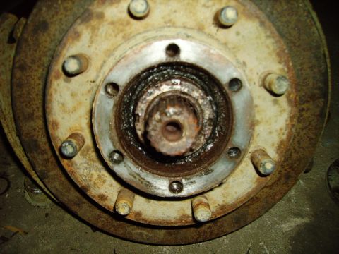 1991 Ford Bronco - Close-up of a heavily rusted wheel hub assembly, showing wear and tear.
