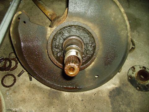 1991 Ford Bronco - Close-up of a heavily rusted brake rotor and hub assembly, showing a splined shaft.