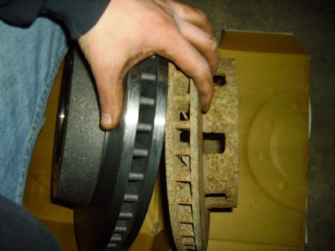 1991 Ford Bronco - Comparing a new brake rotor to a severely rusted old one.