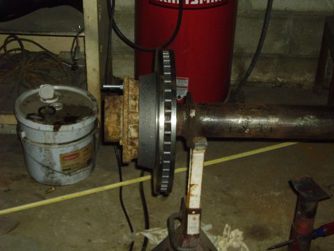 1991 Ford Bronco - A close-up view of an axle assembly with a brake rotor, likely undergoing maintenance or upgrade.