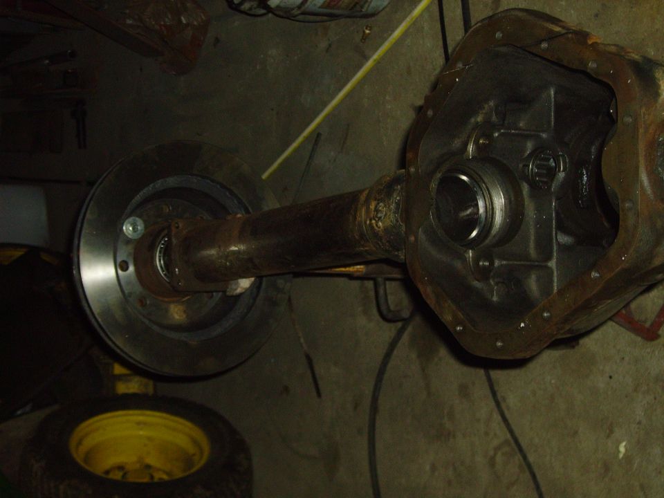 Rear axle housing with diff cover and gears removed, rotor at the axle flange end