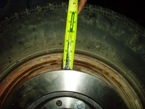 1991 Ford Bronco - A tape measure is used to measure the sidewall height of a tire.