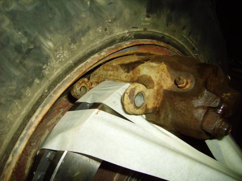 1991 Ford Bronco - Rusty brake caliper and rotor assembly, possibly from a truck or heavy equipment.