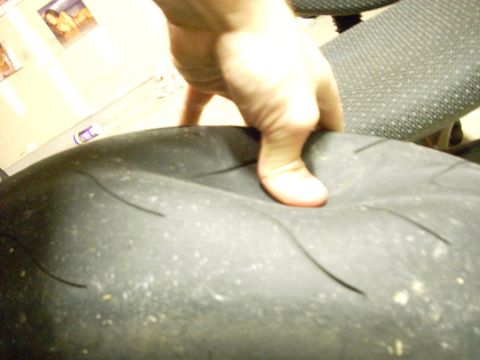 1994 Ford Bronco - A hand presses into the tread of a tire, showing its flexibility.