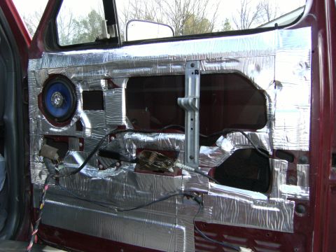 1992 Ford F-150 - The interior door panel is covered in sound deadening material, revealing the internal components and a blue speaker.