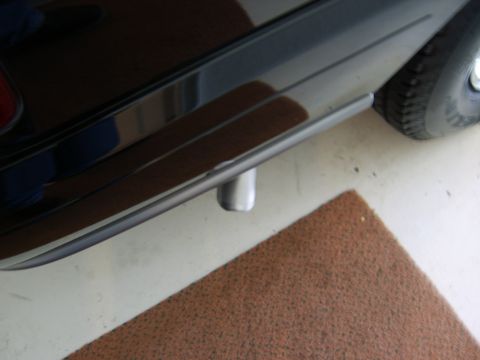 1996 Mercury Grand Marquis - Close-up of a vehicle's rear side, showing the tire and lower body panel.