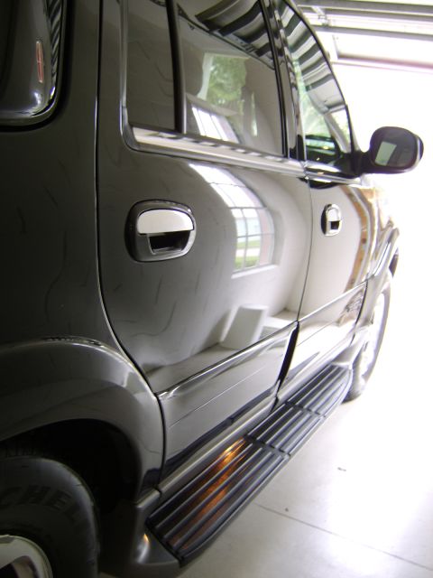 1996 Mercury Grand Marquis - The side of a black Lincoln Navigator is reflected in the garage door.
