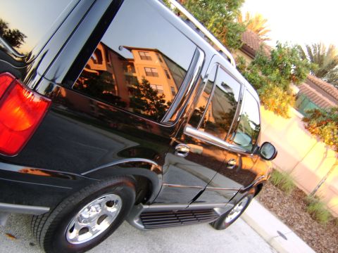 1996 Mercury Grand Marquis - Black SUV parked on a sunny day with reflections in the windows.