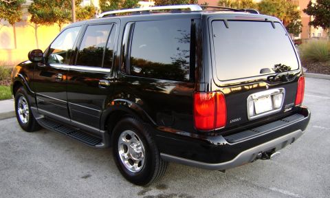 1996 Mercury Grand Marquis - This black Lincoln Navigator SUV is shown from the rear three-quarter view.