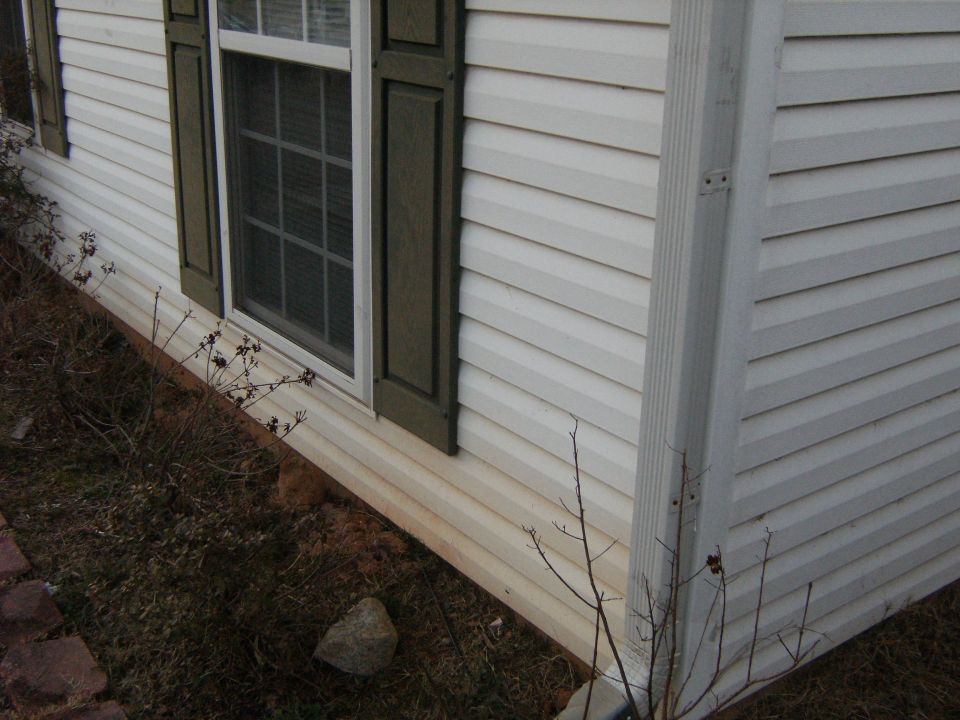 Red clay on the bottom of the siding