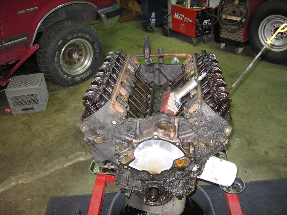 Engine block with valve covers removed, air impact wrench attached