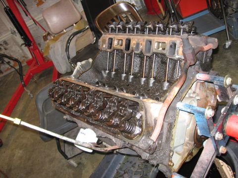 1990 Ford Bronco - Engine block with valve train components exposed, likely undergoing repair or rebuild.