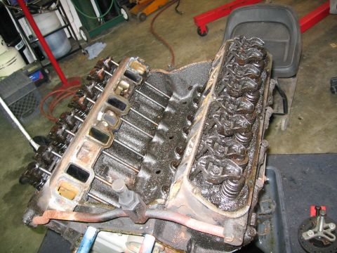 1990 Ford Bronco - Close-up view of an engine with its intake manifold removed, revealing the valve train components.