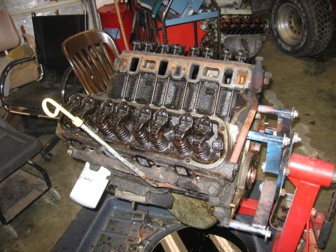 1990 Ford Bronco - Engine block assembly on a stand, showing internal components.
