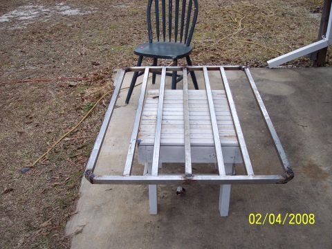 1984 Toyota 4Runner - A metal cargo rack sits on a table outdoors, with a chair in the background.