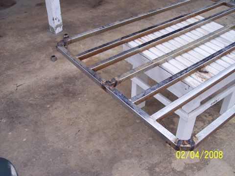1984 Toyota 4Runner - A metal rack is shown resting on white supports on a concrete floor.