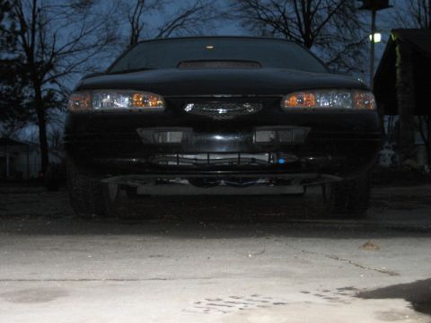 1996 Ford Thunderbird - Front view of a black car parked outdoors at dusk.