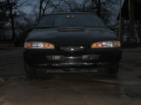 1996 Ford Thunderbird - Front view of a 1996 Ford Thunderbird, showing headlights, grille, and hood scoop.