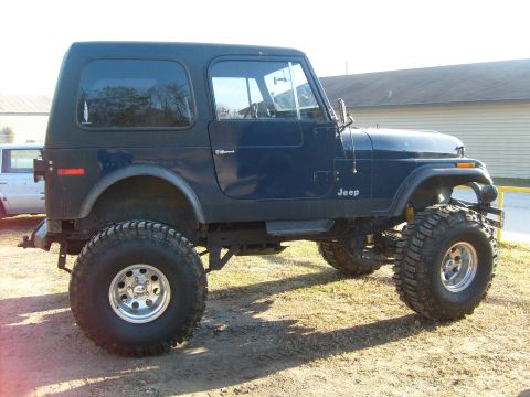1989 Ford Bronco - This dark blue Jeep CJ-7 features a lifted suspension and oversized tires, giving it a stance.