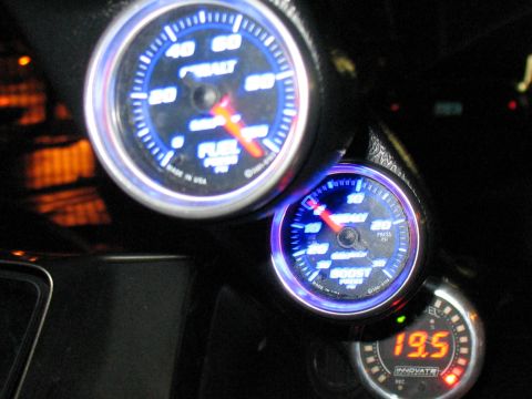 2001 Pontiac Trans Am - Dashboard gauges with blue backlighting show fuel pressure and boost levels.