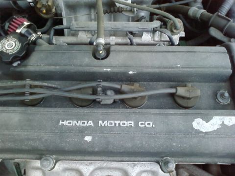 1995 Ford Bronco - Close-up of a Honda engine valve cover with visible text.