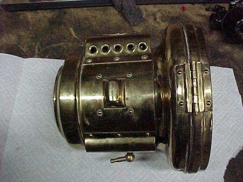 1912 Ford Model T - A brass engine part, possibly from an early automobile, is shown in detail.