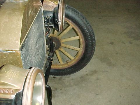 1913 Ford Model T - Detail of a vintage automobile's front wheel, tire, and fender assembly.
