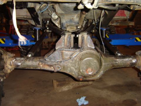 1992 Ford Bronco - Close-up view of the rear axle and suspension components, possibly undergoing modifications or repairs.