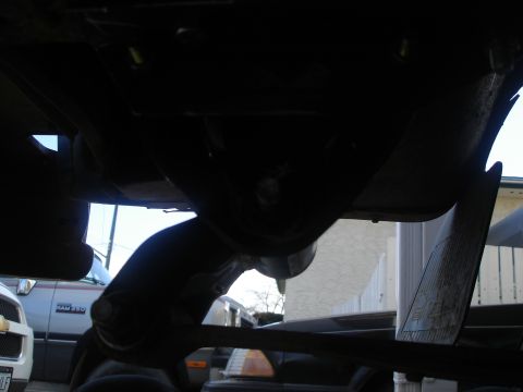 1990 Ford Bronco - Underside view of a vehicle, focusing on suspension and trailer hitch components.