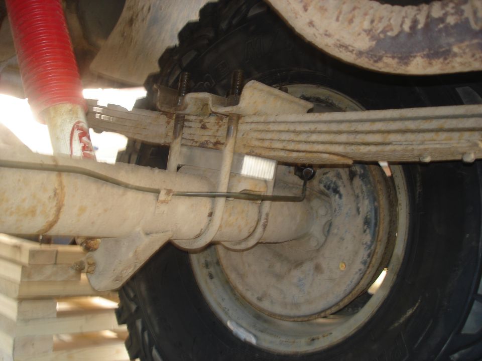 Rear axle and leaf springs with red shock absorber