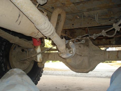 1990 Ford Bronco - Close-up of the rear axle assembly, showing the driveshaft connection and suspension components.
