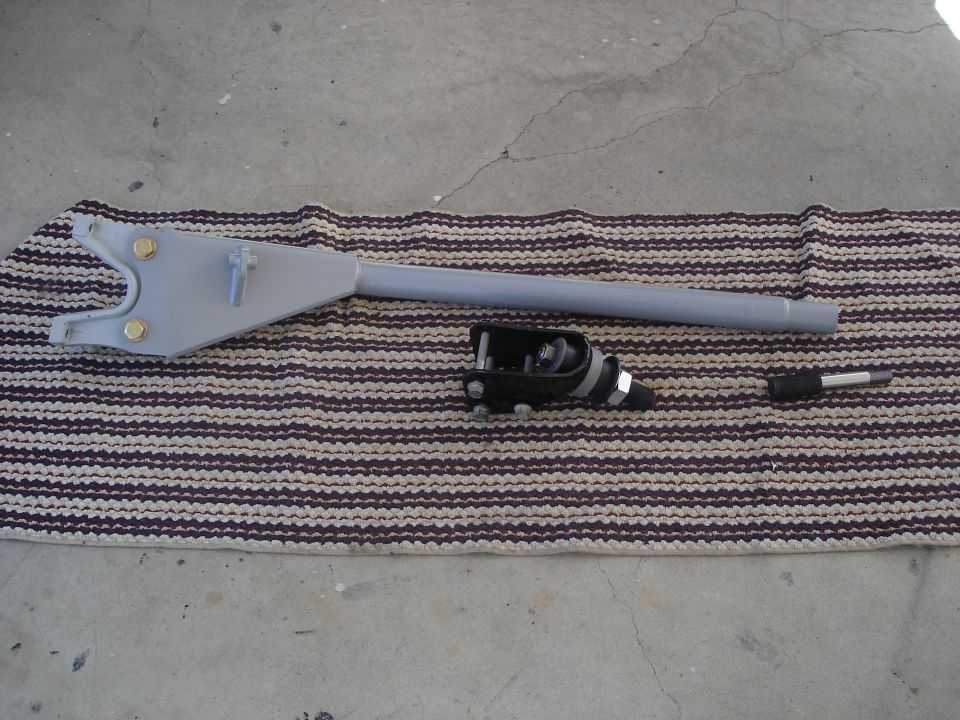 Gray parking brake lever assembly with black actuator on striped mat