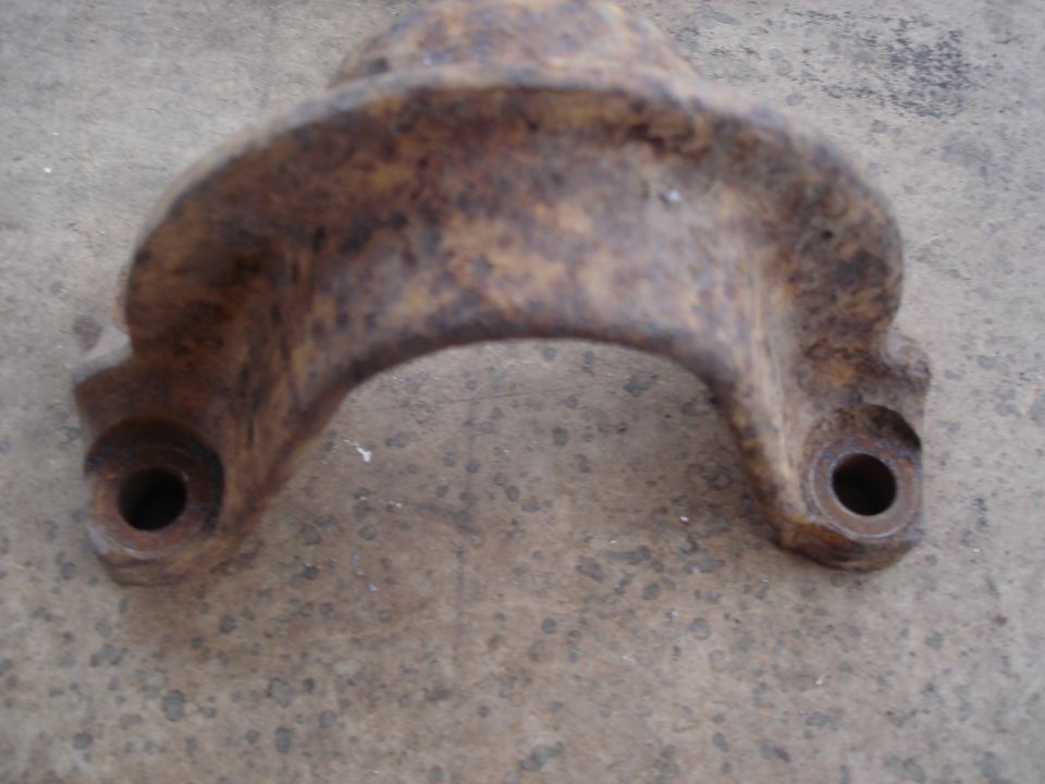rusted metal bracket with two bolt holes